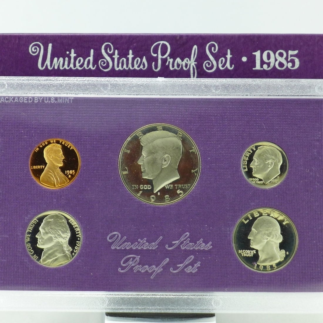 1985 United States Proof Set, 5 Coins Inside!: 1985 United States Proof Set, 5 Coins Inside!. Original packaging: The coins of the 1985-S Proof Set were placed in individual holes in a purple-colored, textured paper and cardboard insert, then seal
