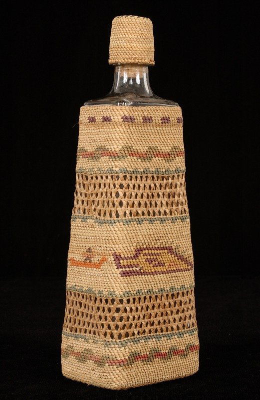 Nuu-chah-nulth Basketry Covered Bottle with Man in: Nuu-chah-nulth Basketry Covered Bottle with Man in Canoe Hunting Sea Monster and Whale 11" H. 3 1/2" W. Fine Condition