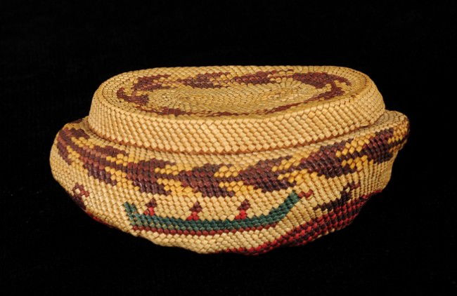 Nuu-chah-nulth Basketry Covered Abalone Shell with: Nuu-chah-nulth Basketry Covered Abalone Shell with Lid - Bird and Canoe Design 4 1/4" L. 2" H. Fine Condition
