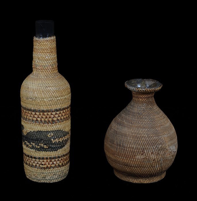 Nuu-chah-nulth Basketry Covered Bottle Whale Desig: Nuu-chah-nulth Basketry Covered Bottle Whale Design 11" H. 3" D. Good Condition and Nuu-chah-nulth Basketry Covered Ceramic Pot 6 1/2" H. 5" D. As Is, Both From the Forestry Museum - Duncan, B.C.