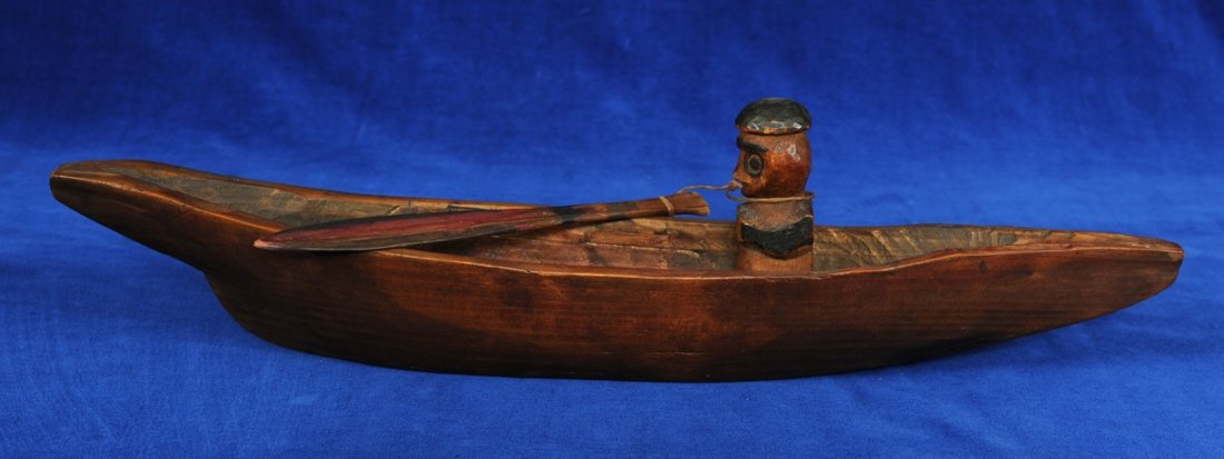 Northwest Coast Canoe Carved with Paddler and Paddle: Northwest Coast Canoe Carved with Paddler and Paddle 12" L. 4" W. Good Condition