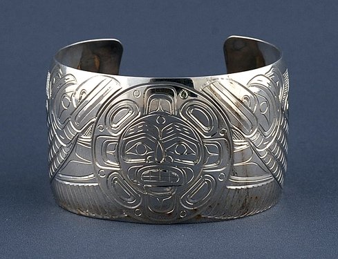 Northwest Coast Silver Bracelet with Incised Raven and: Northwest Coast Silver Bracelet with Incised Raven and Moon Design by W. Cooke 6 1/4" L. 1 1/2" W. 1 1/8" W. Gap Fine Condition