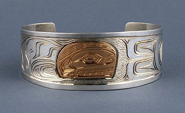 Northwest Coast Silver and Gold Bracelet with Incised: Northwest Coast Silver and Gold Bracelet with Incised Whale Design by Richard Baker 7" L. 1 1/8" W. 1 1/2" W. Gap Gap Fine Condition