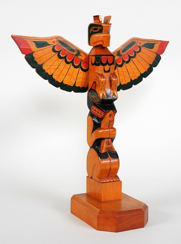 Quatsino Sound Totem Carved with Thunderbird and Bear: Quatsino Sound Totem Carved with Thunderbird and Bear Holding a Salmon 15" H. 13 1/2" W. Good Condition with Chip on One Ear and Repair To Wing