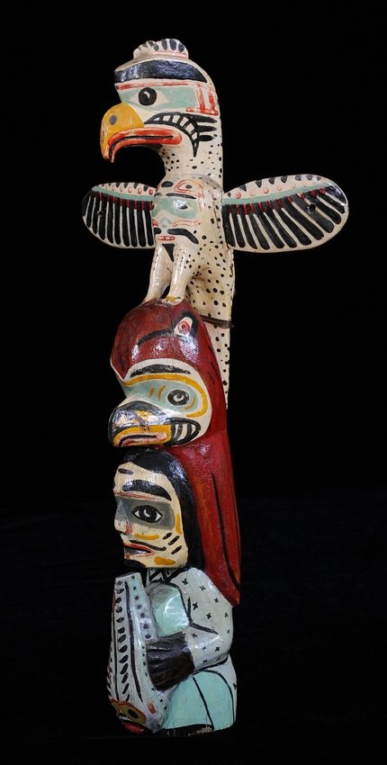 Totem Given to Mrs Thiemer by Mungo Martin, Carved with: Totem Given to Mrs Thiemer by Mungo Martin, Carved with Thunderbird, Octopus and Shaman Holding a Sculpin 13" H. 7 5/8" W. Good Condition