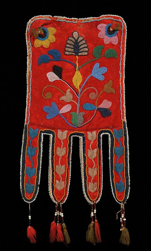 Red River Metis Beaded Octopus Bag ca. 1840-1860 with: Red River Metis Beaded Octopus Bag ca. 1840-1860 with Floral Design on Red Trade Cloth and Wool Tassels 17" L. 8" W. Good Condition with Minor Loss to Beads and Cloth