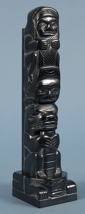 Haida Argillite Totem Carved with Three Figures on a: Haida Argillite Totem Carved with Three Figures on a Frog Base by Tom Hans 9" H. 2 1/8" W. Good Condition