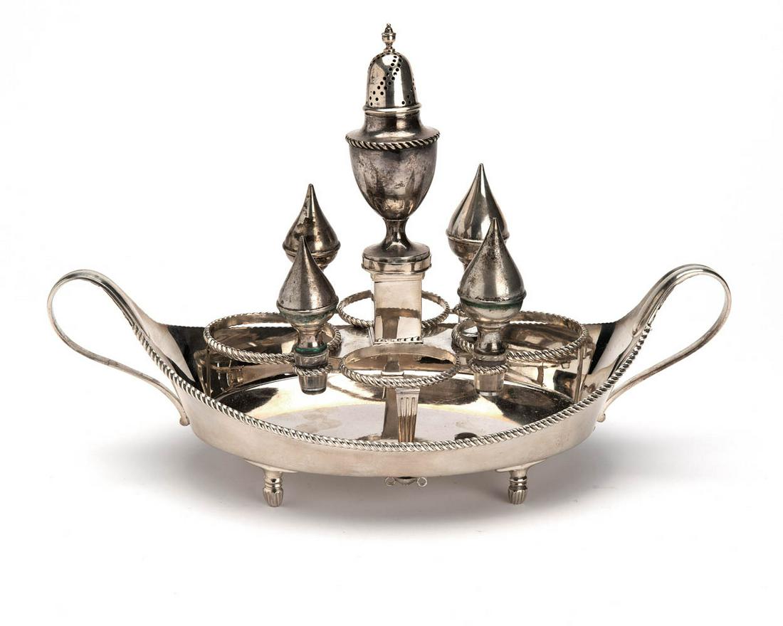 A Dutch silver holder for oil and vinegar: An oval holder with small caster, the cut-glass flasks are missing, only the silver stoppers are left. Maker D. Pijzel, The Hague, 1812-1836. 835/1000.