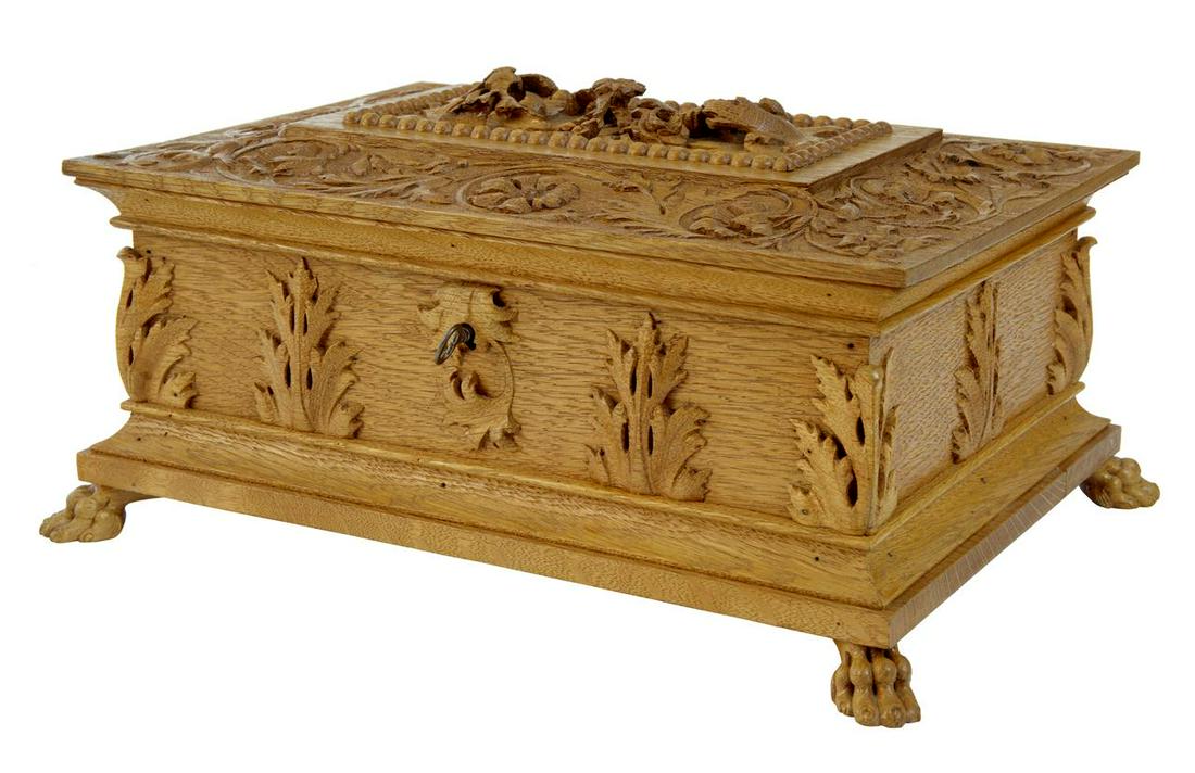 LATE 19TH CENTURY DECORATIVE CARVED OAK BOX: HEAVILY CARVED OAK BOX CIRCA 1890. POSSIBLY A CIGAR BOX. CARVED WITH FLORALS ALLOVER AND OUT OF THE SOLID ON THE LID. STANDING ON PAW FEET. SPLIT TO BASE, BUT NOT STRUCTURAL. Dimensions: =========== H