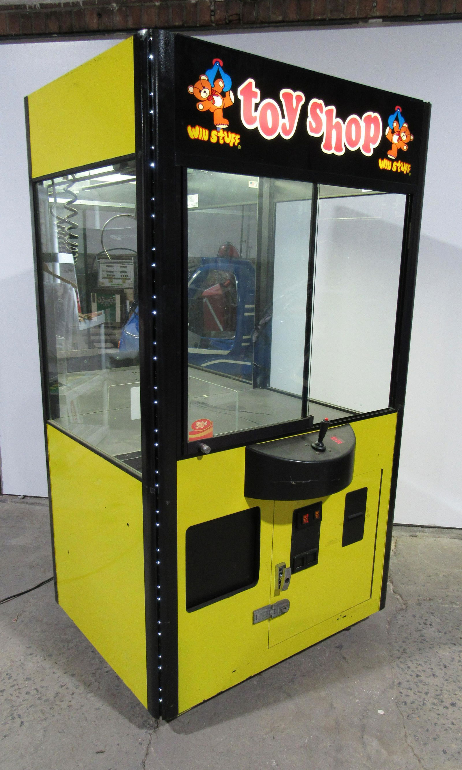 Toy Shop Yellow Crane Coin Operated Arcade Game: Toy Shop Yellow Crane Coin Operated Arcade Game, working. Locks and bill acceptor not included. This item requires third party shipping or pickup arrangements to be made. Dimensions: 75 x 42 x 40