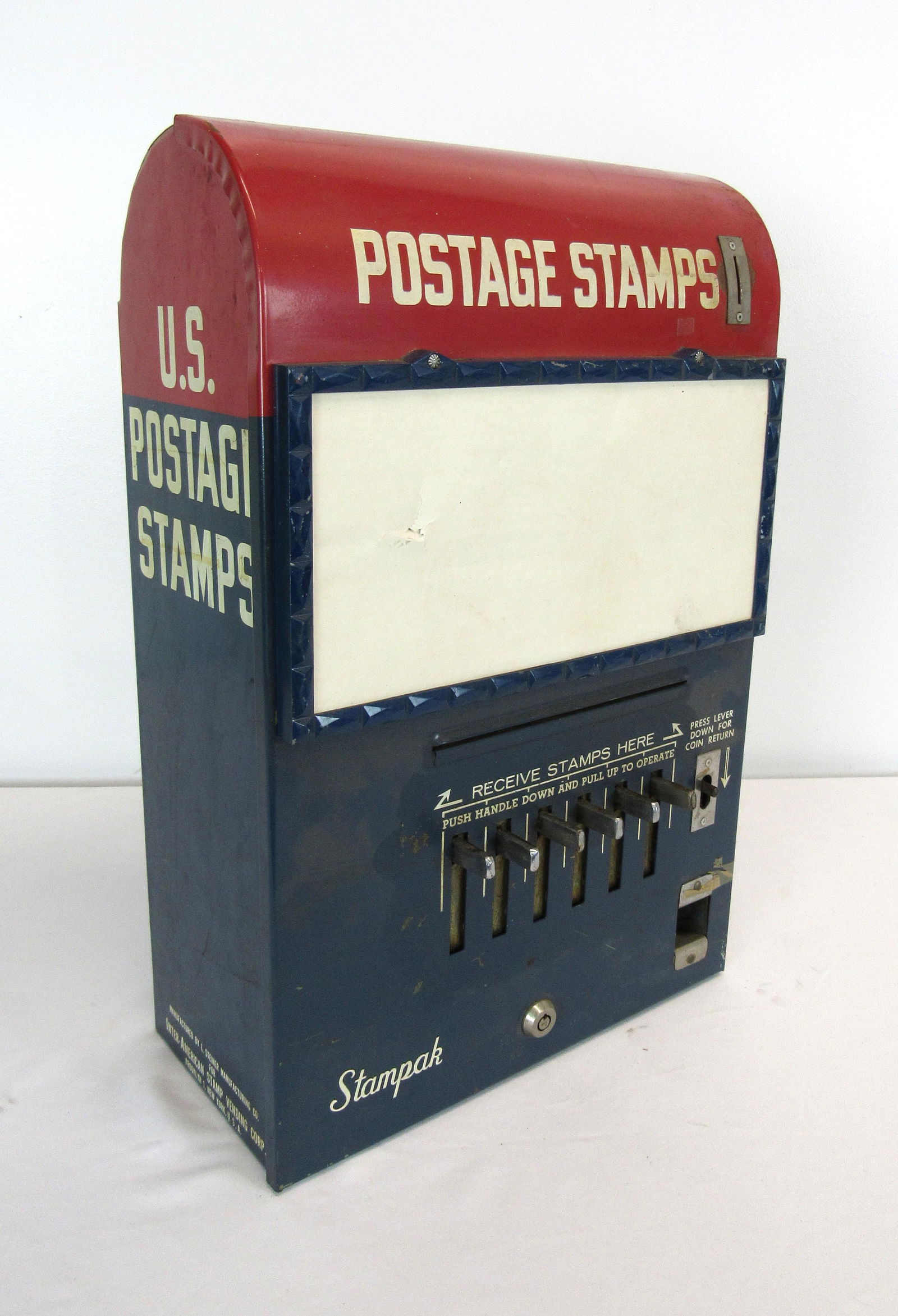 Red and Blue Metal Stamp Vendor With Sign Front: Red and Blue Metal Stamp Vendor With Sign Front. This item requires third party shipping or pickup arrangements to be made. Dimensions: 20 x 12 x 8