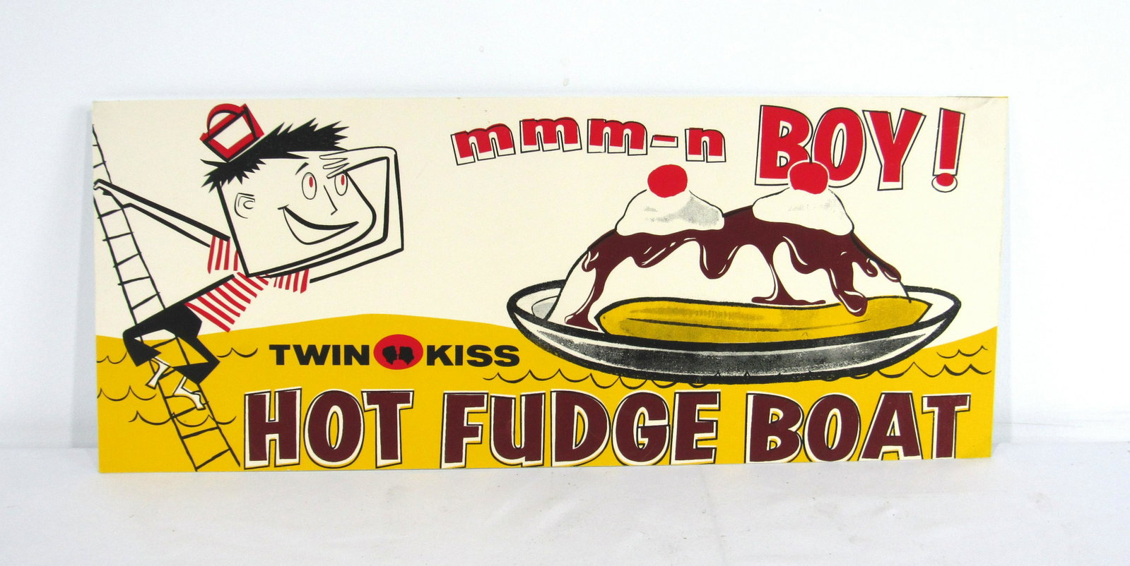 Twin Kiss Hot Fudge Boat Advertising Sign: Twin Kiss Hot Fudge Boat Advertising Sign. In-house shipping available. Dimensions: 20x8.25