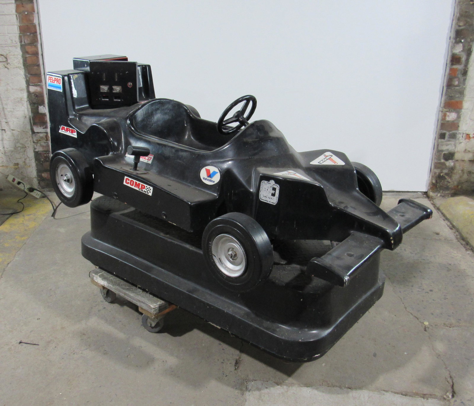 Black Coin-Operated Race Car Kiddie Ride: Black Coin-Operated Race Car Kiddie Ride. Working, no sound. Lock not included. This item requires third party shipping or pickup arrangements to be made. Dimensions: 37x33x64