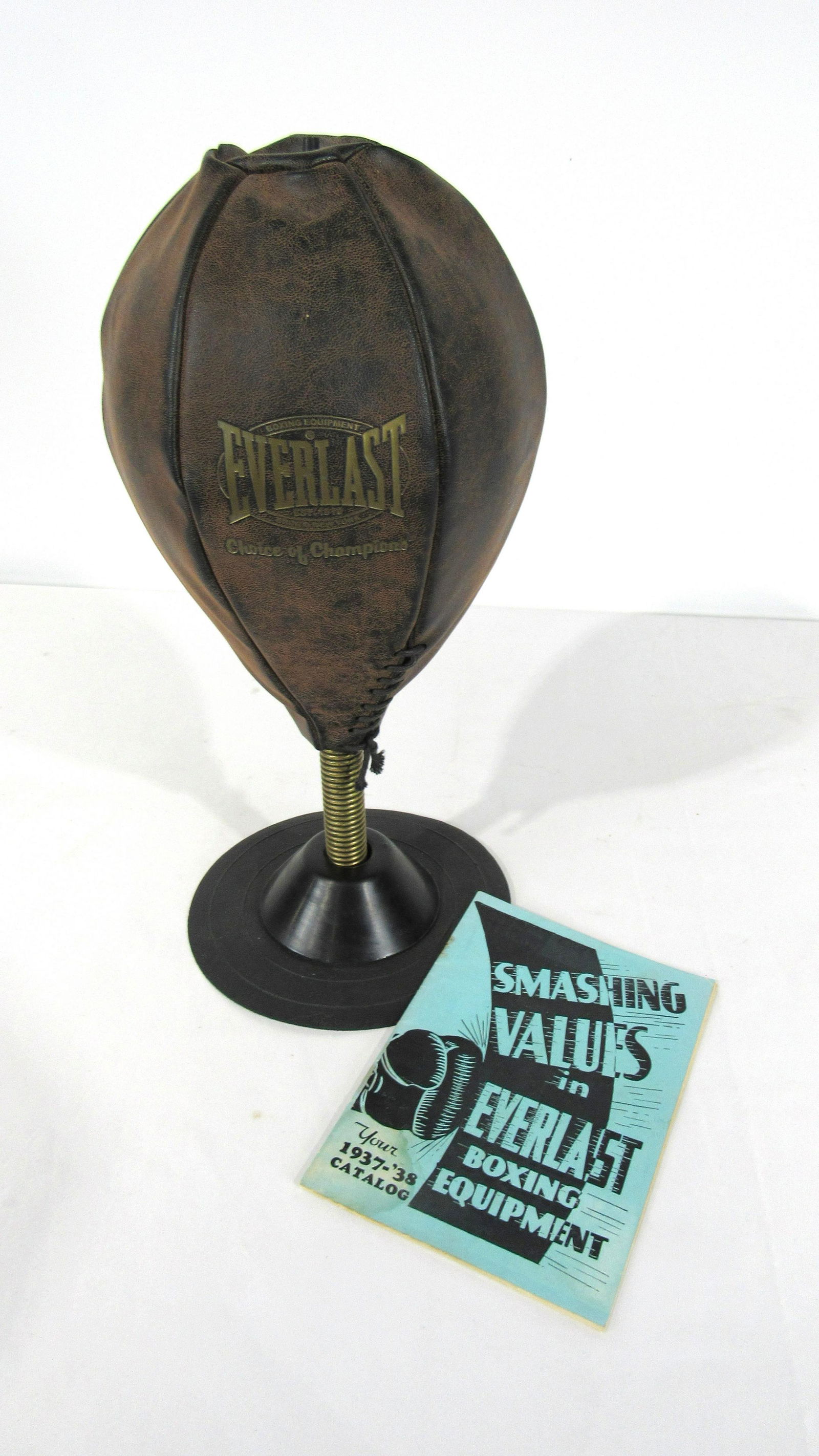 Leather Everlast Tabletop Punching Bag with 1930s: Leather Everlast Tabletop Punching Bag with 1930s Catalog. Dimensions: 16 x 8 x 8