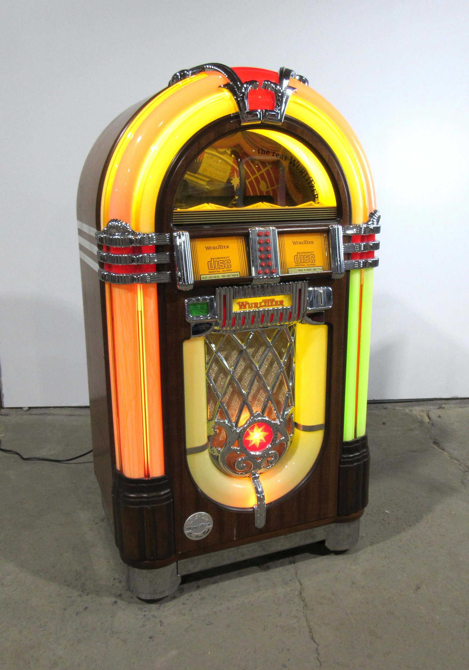 Wurlitzer One More Time CD Coin Operated Jukebox: Wurlitzer OMT 50 CD Coin Operated Jukebox, needs repair. Left plastic needs replaced. This item requires third party shipping or pickup arrangements to be made. Dimensions: 60 x 34 x 26