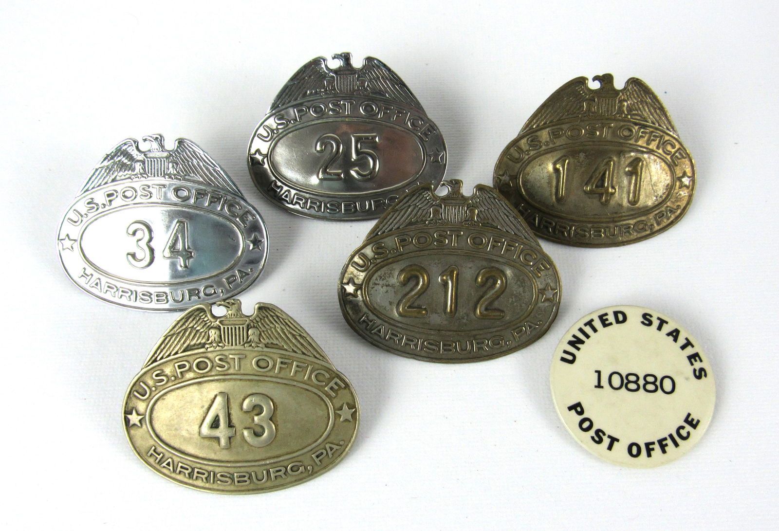 Post Office Badges from Harrisburg, PA: Five Post Office Letter Carrier Badges from Harrisburg, PA and one seasonal worker button. In-house shipping available.