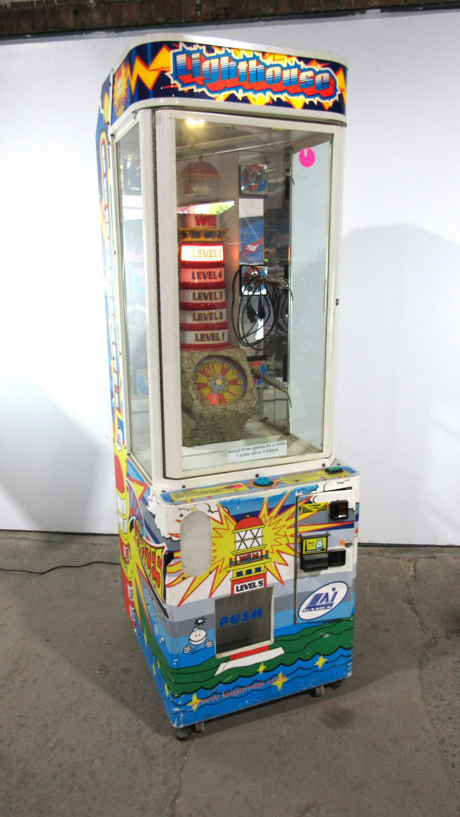 LAI Games The Lighthouse Prize Redemption Arcade Game: LAI Games The Lighthouse Prize Redemption Arcade Game. Working, no sound. Bill acceptor included, no key but front bottom door is unlocked. This item requires third party shipping or pickup arrangemen
