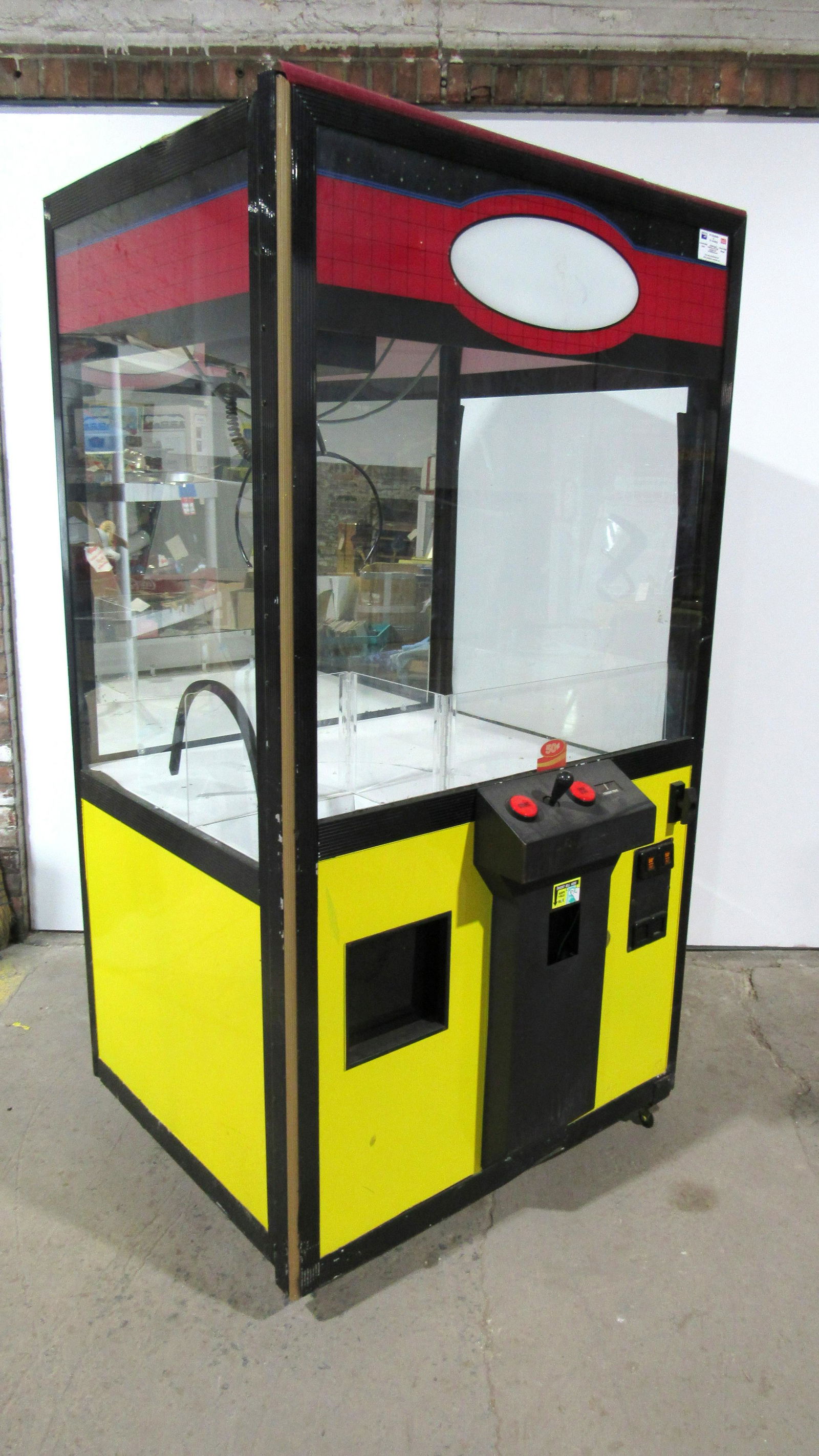 Yellow Premier Coin Operated Arcade Crane Machine: Yellow Premier Coin Operated Arcade Crane Machine, partially working. Reverse on joystick not working. Locks and bill acceptor not included. Dimensions: 79 x 43 x 42