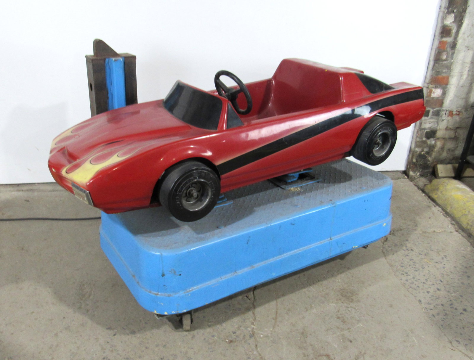 Red Flames Car Coin Operated Kiddie Ride: Red Flames Car Coin Operated Kiddie Ride. Untested, needs new cord end. This item requires third party shipping or pickup arrangements to be made. Dimensions: 40 x 42 x 70