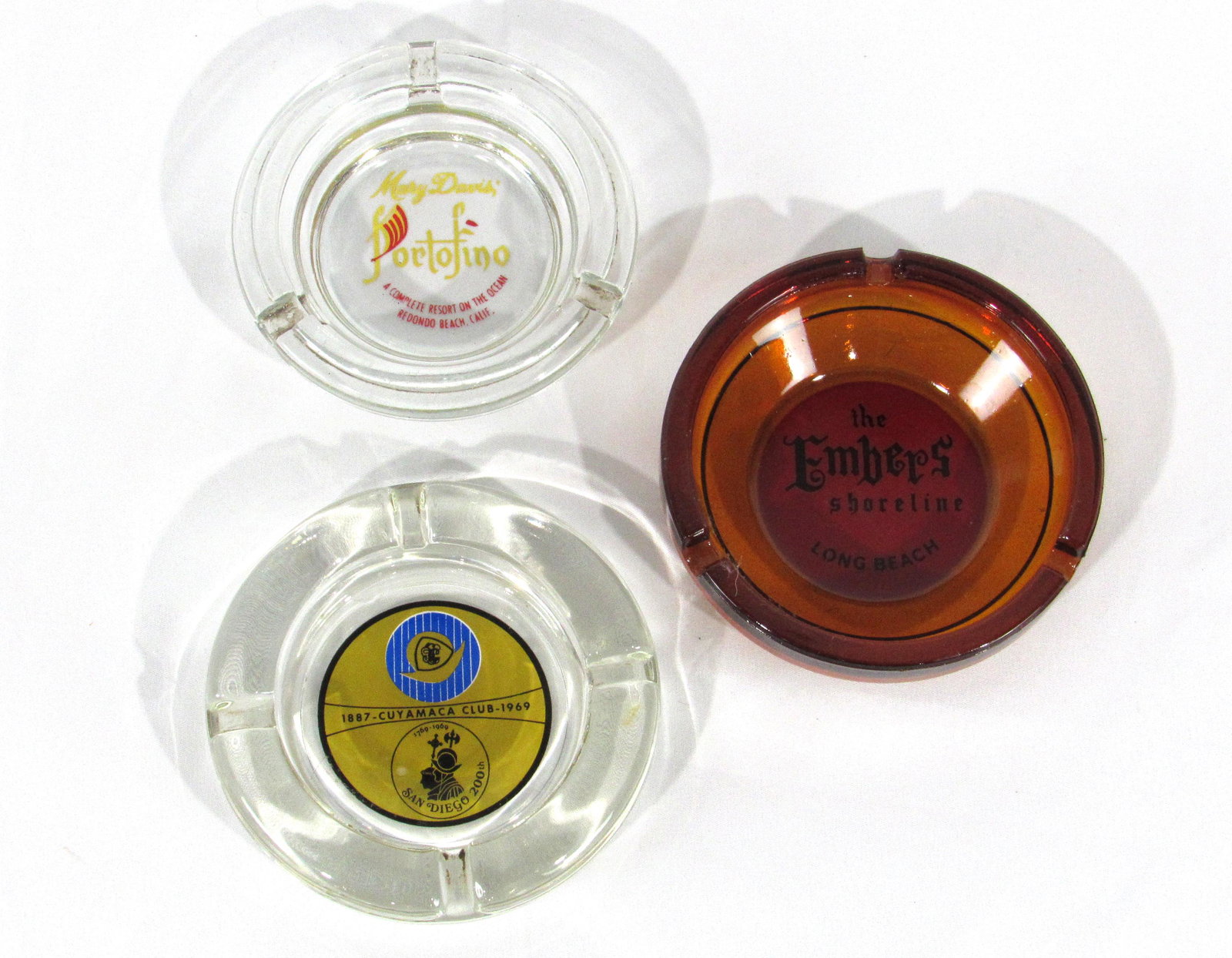 Three Vintage Advertising Ashtrays including The Embers: Three Vintage Advertising Ashtrays including The Embers, Long Beach. Also included, Cuyamaca Club and Portofino in Rodondo Beach, California. In-house shipping available. Dimensions: 4 x 4 x 1