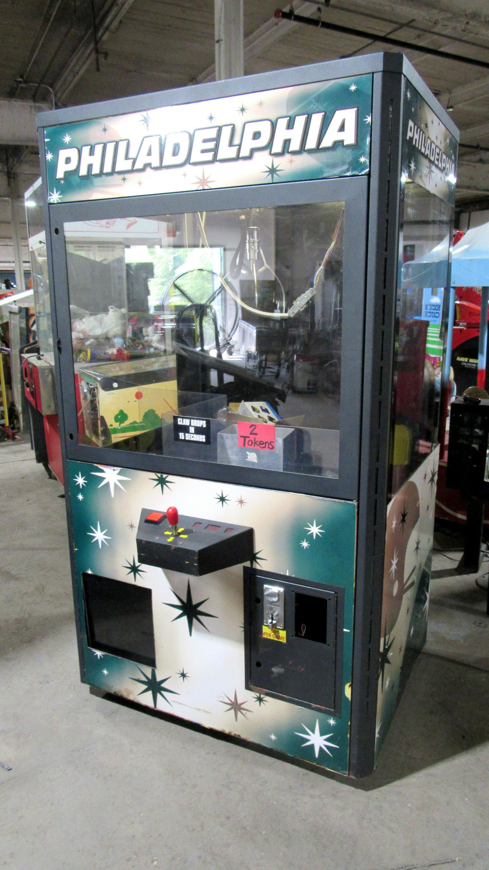 Philadelphia Football Themed Coin Operated Crane Arcade: Philadelphia Football Themed Coin Operated Crane Arcade Game. Powers on with error, spare board included. This item requires third party shipping or pickup arrangements to be made. Dimensions: 75 x 43