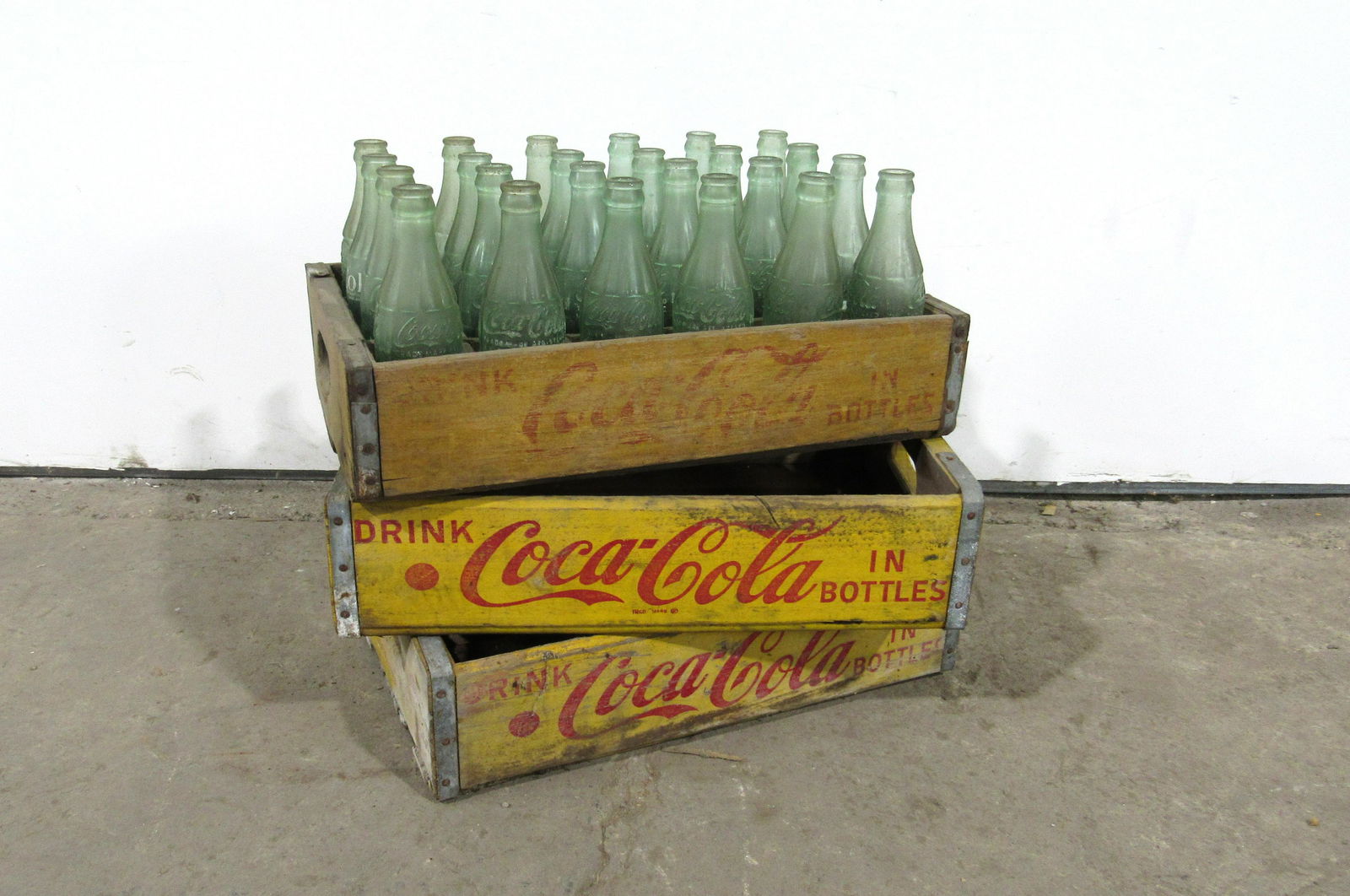 Three Vintage Coca-Cola Crates with Bottles: Three Vintage Coca-Cola Crates with Bottles. This item requires third party shipping or pickup arrangements to be made. Dimensions of crate with bottles: 8 x 12 x 18