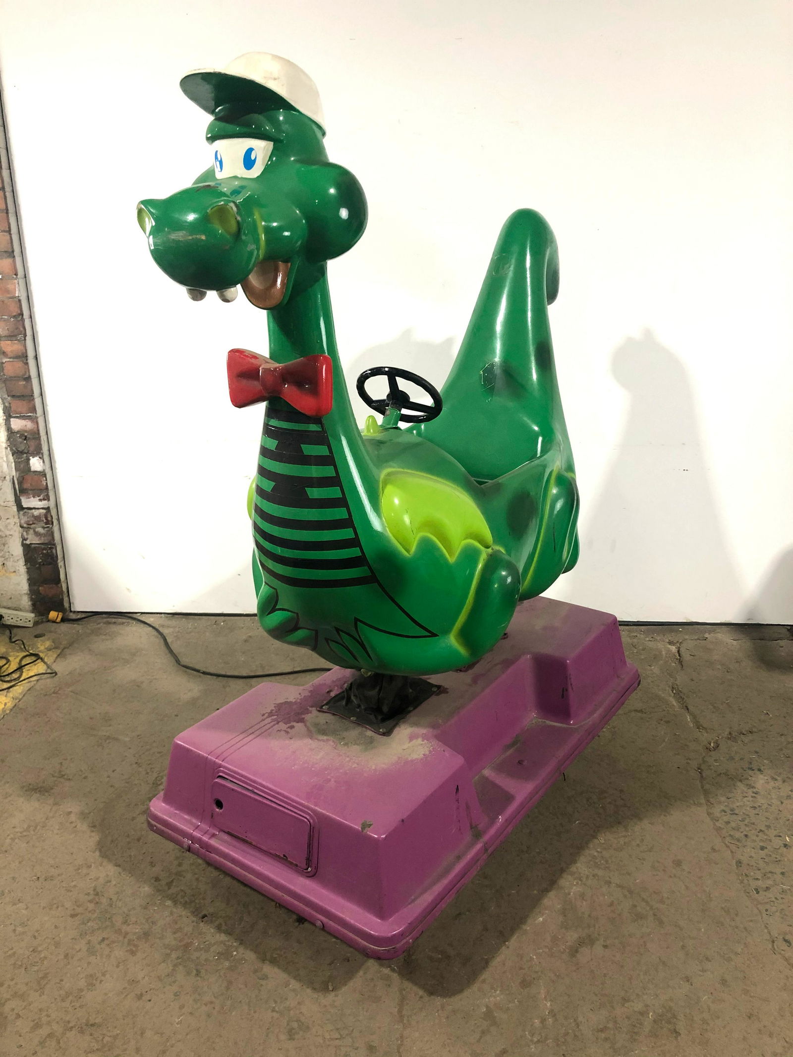 Harry the Happy Dragon Coin Operated Kiddie Ride: Harry the Happy Dragon Coin Operated Kiddie Ride. Working, no sound. Made for Harris Teeter. This item requires third party shipping or pickup arrangements to be made. Dimensions: 62 x 27 x 68