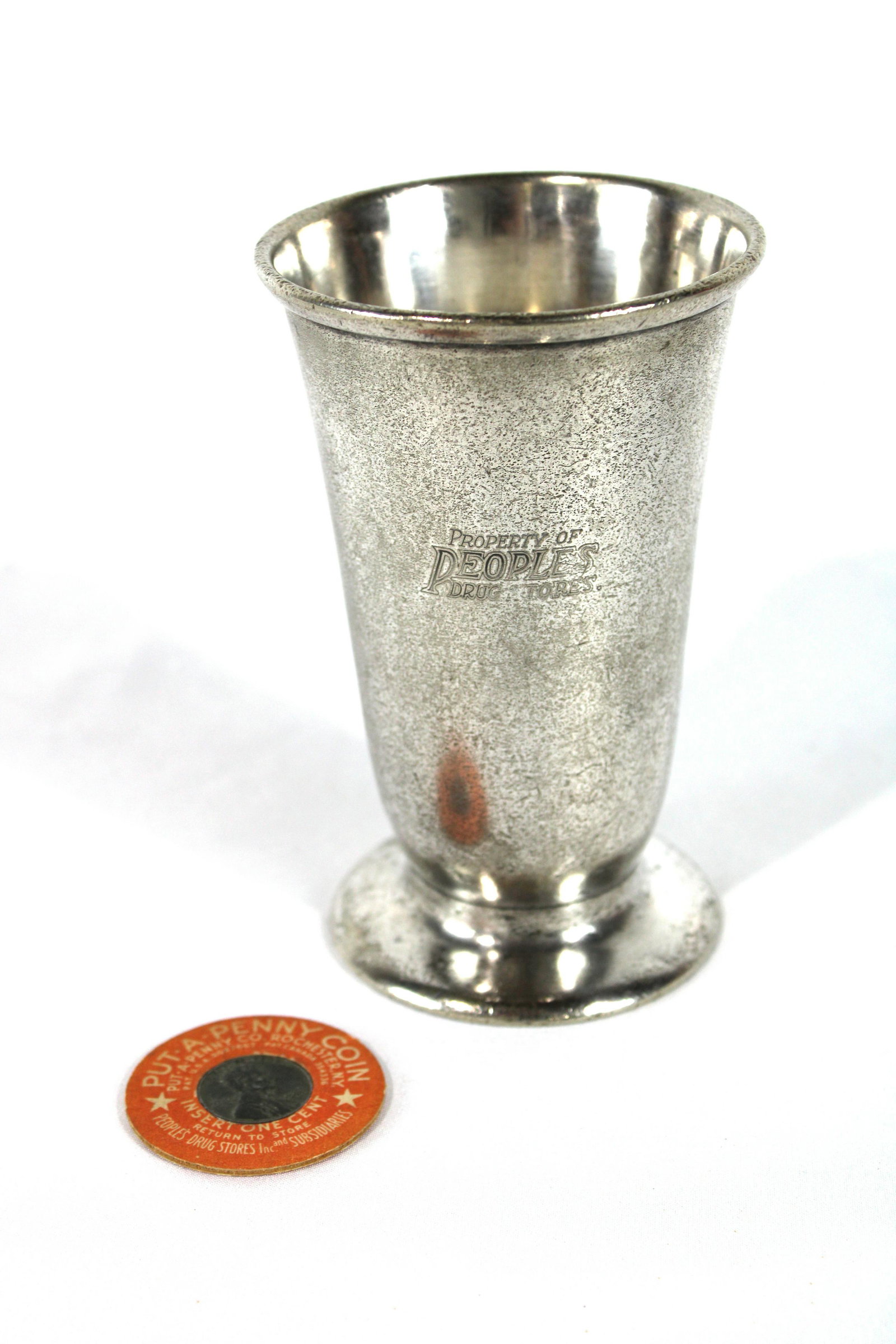 People's Drug Store Metal Malted Milk / Sundae Cup: People's Drug Store Metal Malted Milk / Sundae Cup. Heavy Metal Cup retains most of it's original nickel plating and includes a lucky penny from same store. In-house shipping available. Dimensions:
