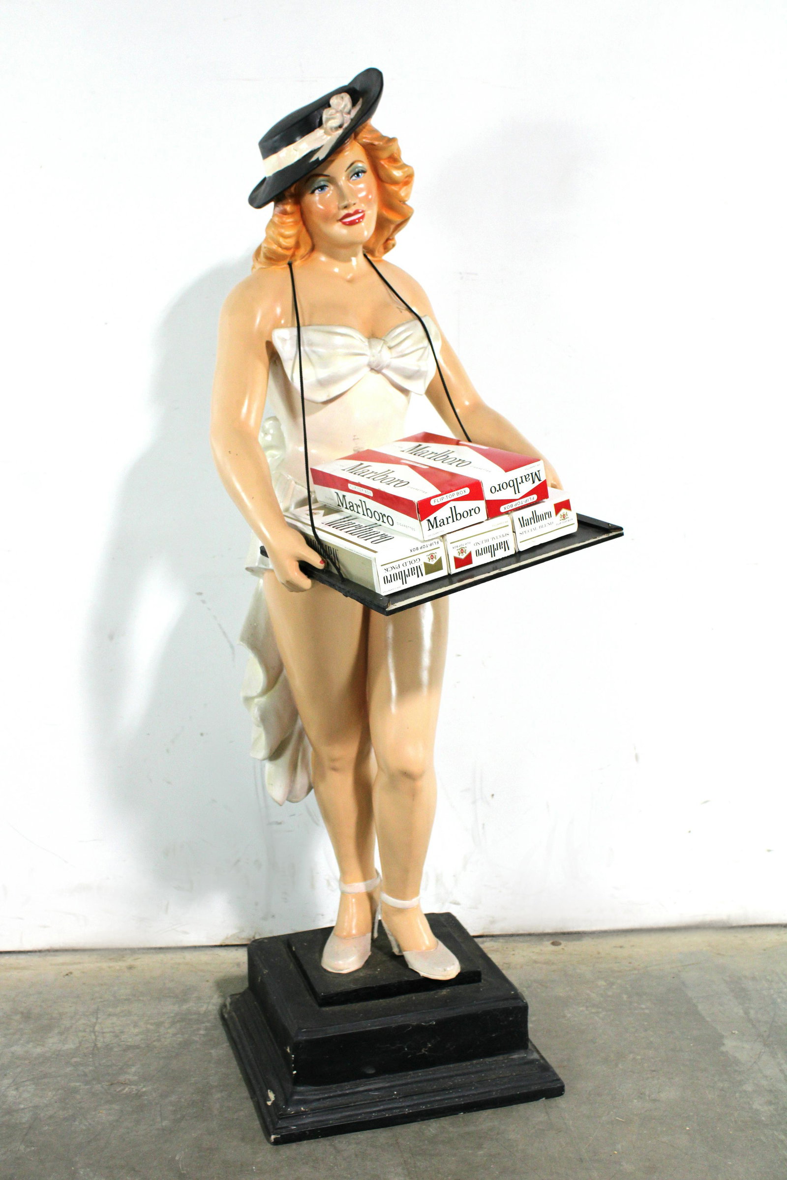 5FT Cigarette Girl Statuette: 5FT Cigarette Girl Statuette. Tray needs repaired. This item requires third party shipping or pickup arrangements to be made. Dimensions: 59 x 24 x 24