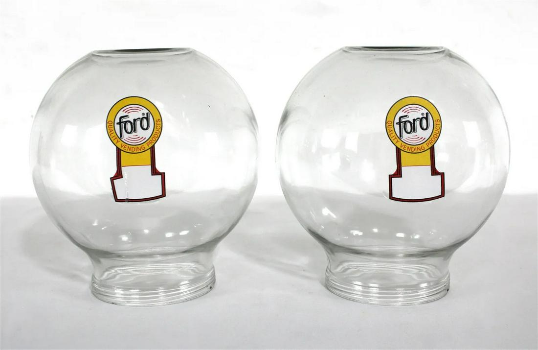 Pair of Ford Glass Gumball Globes, Lot 2: Pair of Ford Glass Gumball Globes. This item requires third-party shipping or pickup arrangements to be made. Dimensions of One: 8 x 8 x 8