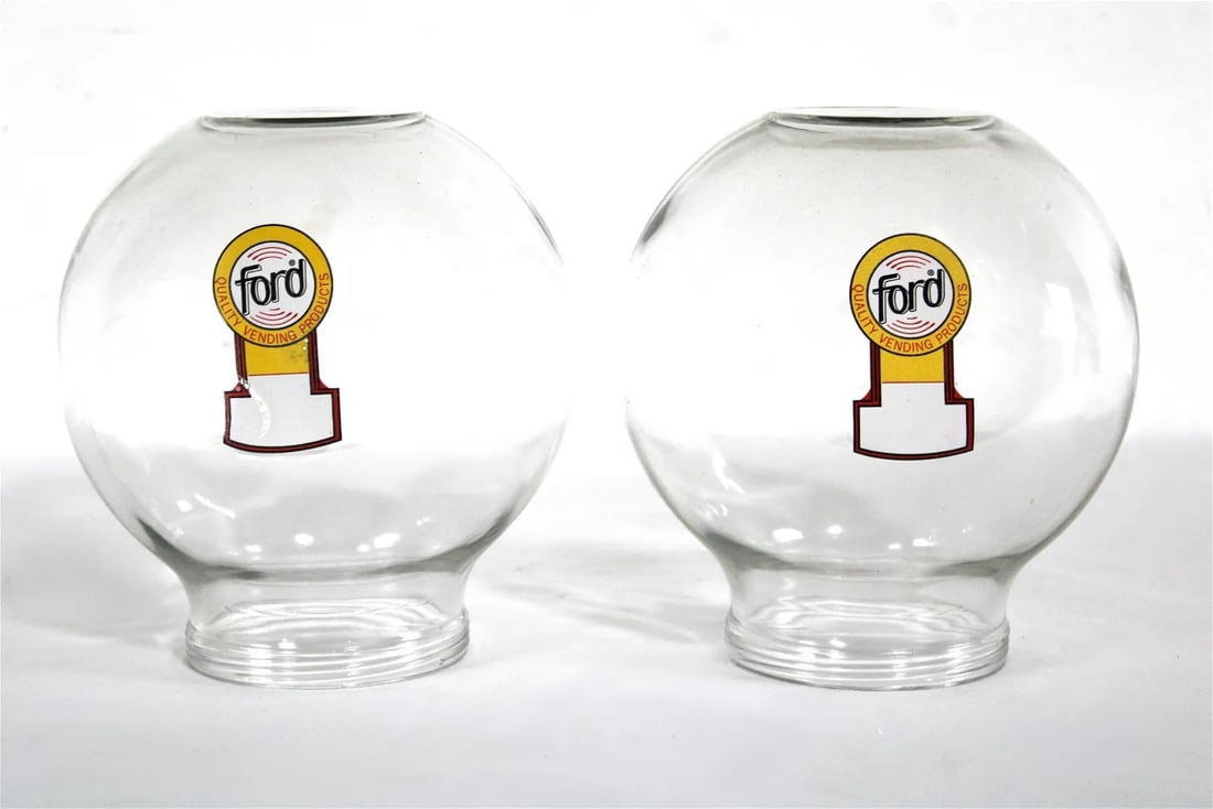 Pair of Glass Ford Gumball Globes: Pair of Glass Ford Gumball Globes. This item requires third party shipping or pickup arrangements to be made. Dimensions of One: 8 x 8 x 8