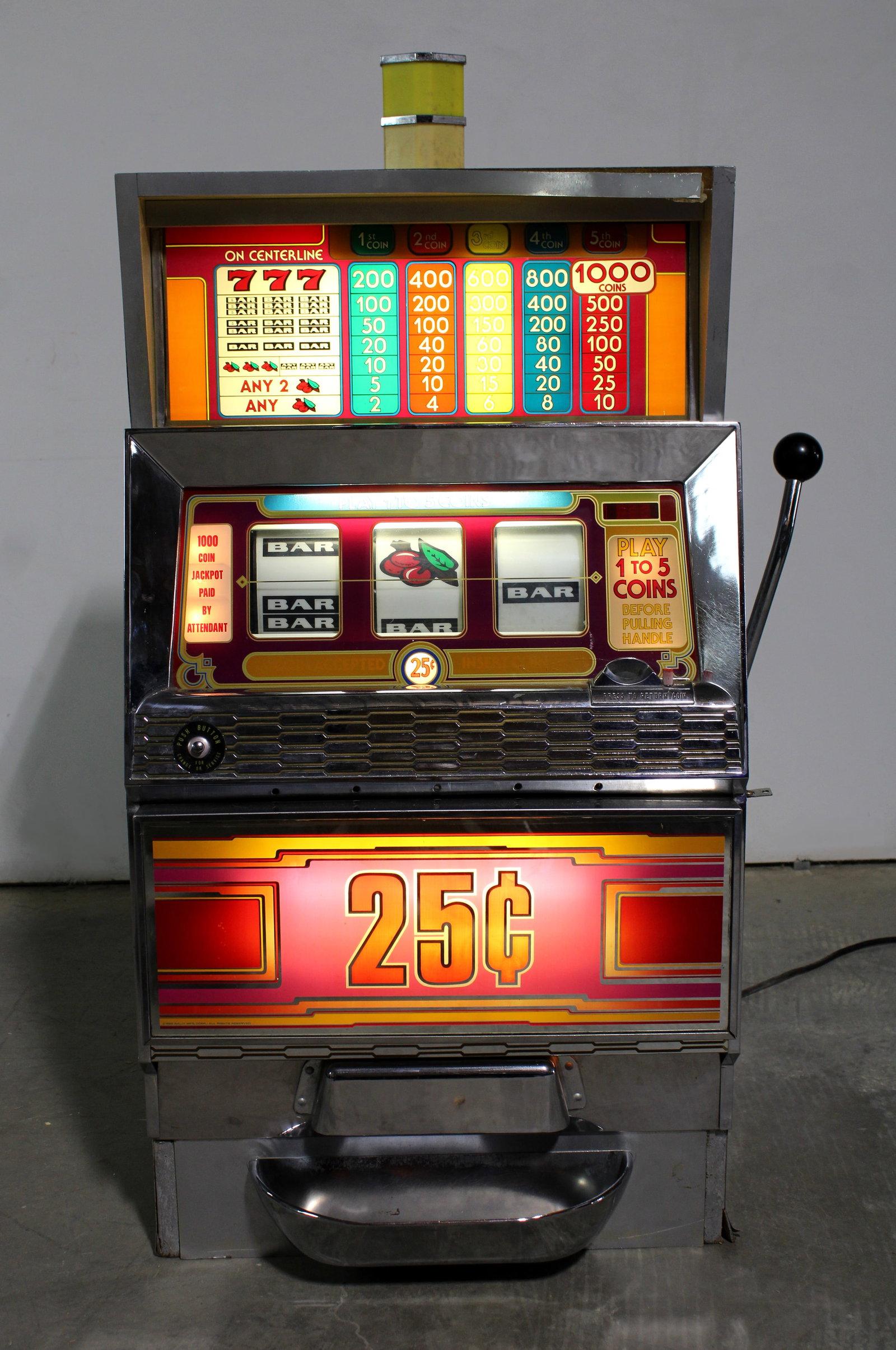 25 Cent Slot Machine: Lights up, does not appear to be working. Has key. This item requires third-party shipping or pickup arrangements to be made. Dimensions: 45 x 28 x 24