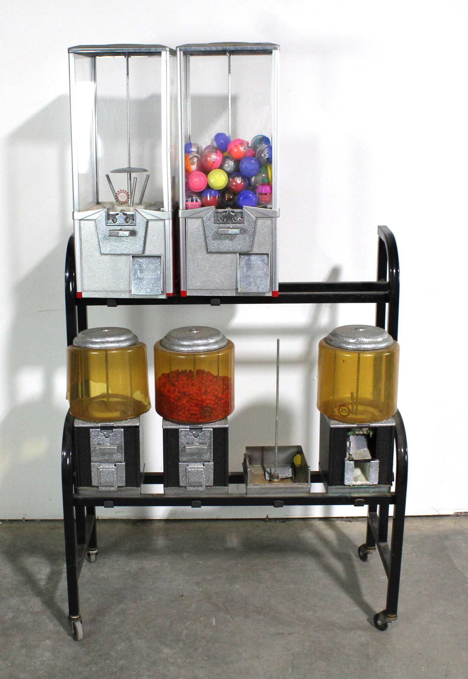 Coin Operated Gumball Machines on Stand: Varying conditions. One broken globe. This item requires third-party shipping or pickup arrangements to be made.