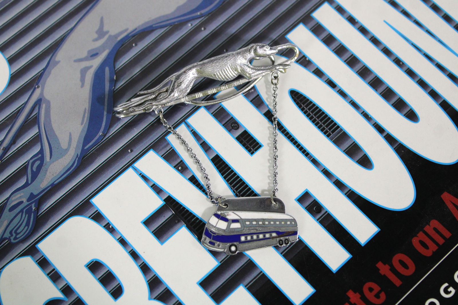 Early Enamel Greyhound Bus Tie Bar with Book (1 of 2)