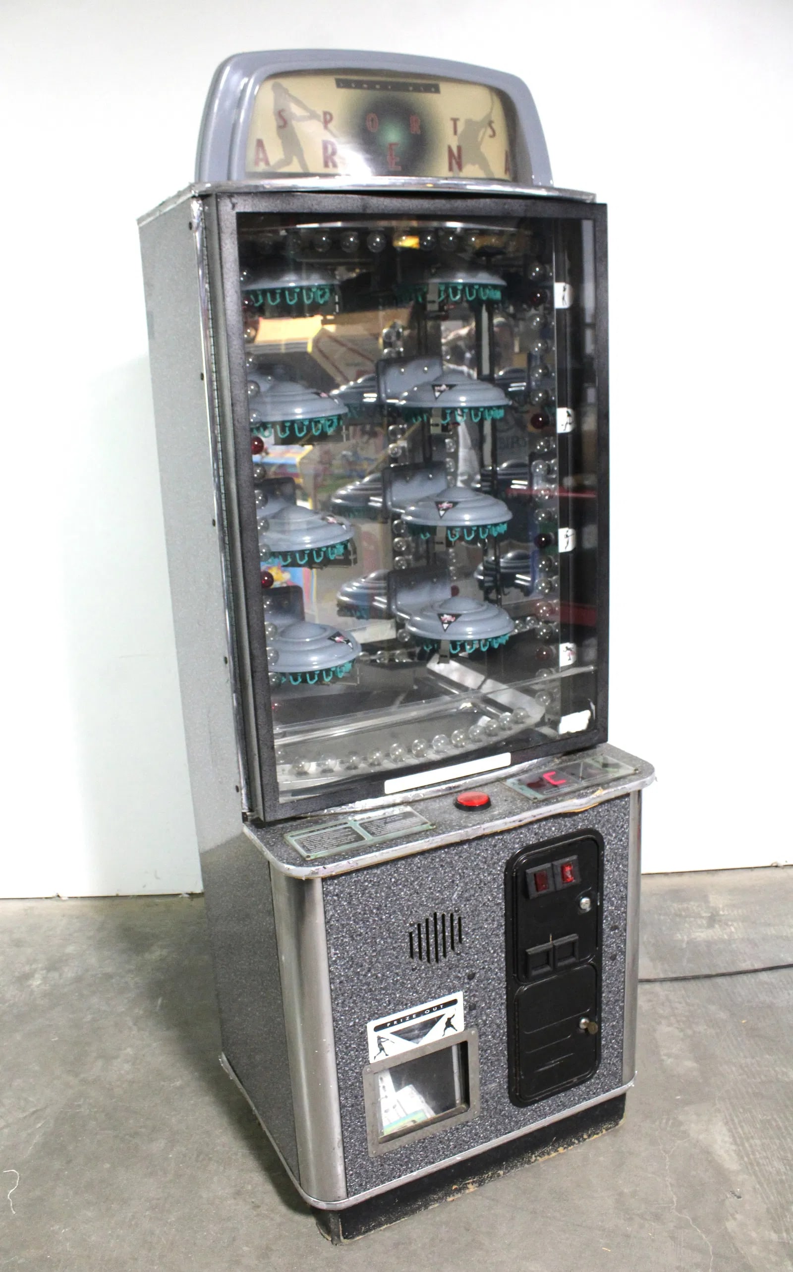 Sports Arena Prize Arcade Game: Powers on, not working. This item requires third party shipping or pickup arrangements to be made. Dimensions: 77 x 28 x 28