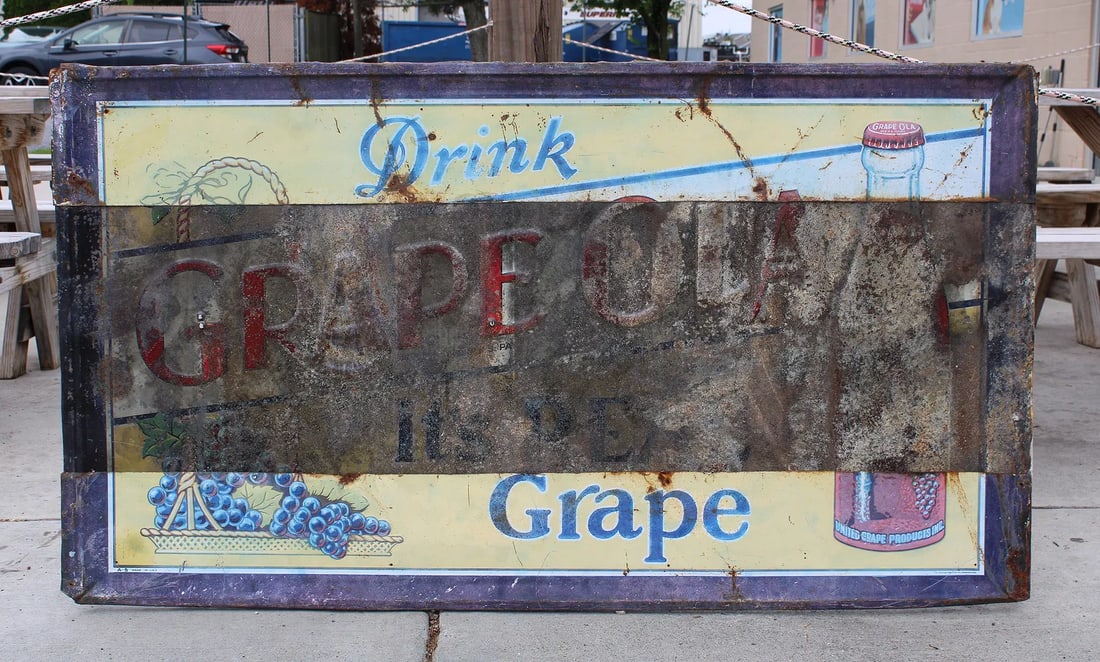 Drink Grapeola Advertising Sign: This item requires third-party shipping or pickup arrangements to be made. Dimensions: 32 x 57 x 1