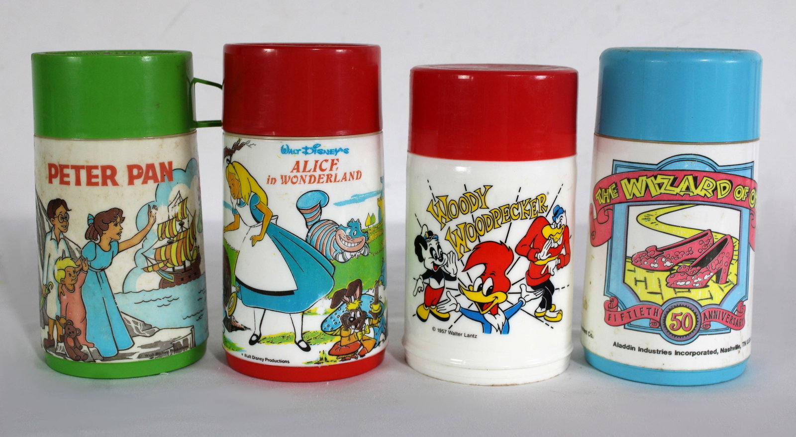 Aladdin Vintage Thermoses Incl. Wizard of Oz, Peter Pan, Alice in Wonderland: Also includes Woody Woodpecker. Total of 4. In-house shipping available.