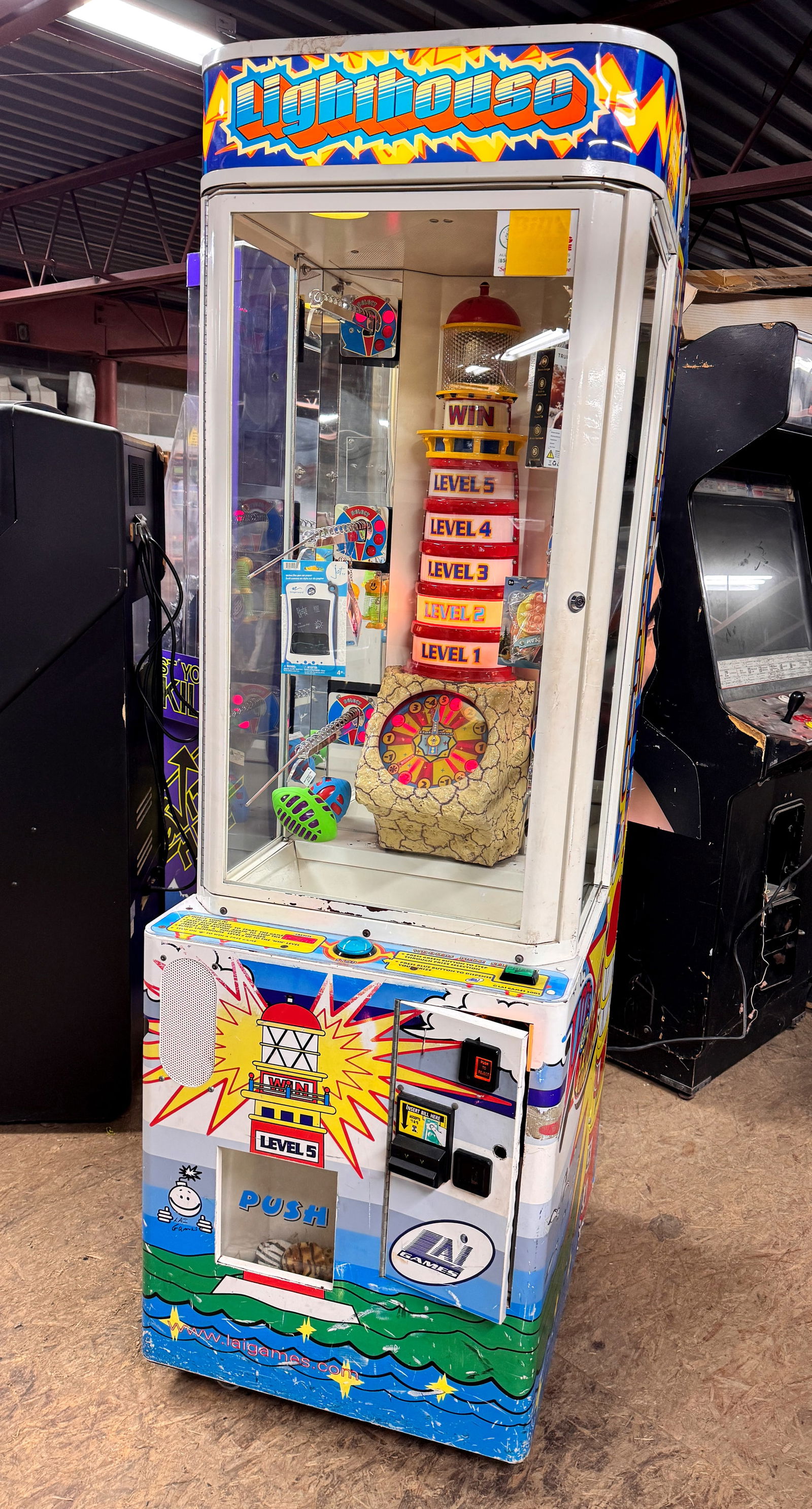 LAI Games Lighthouse Arcade Game: Working. Dimensions: 79 x 25 x 31 ***This is a remote auction in Sewell, New Jersey. Pickup or third-party shipping is required on this item. A list of suggested shippers can be found in the terms of