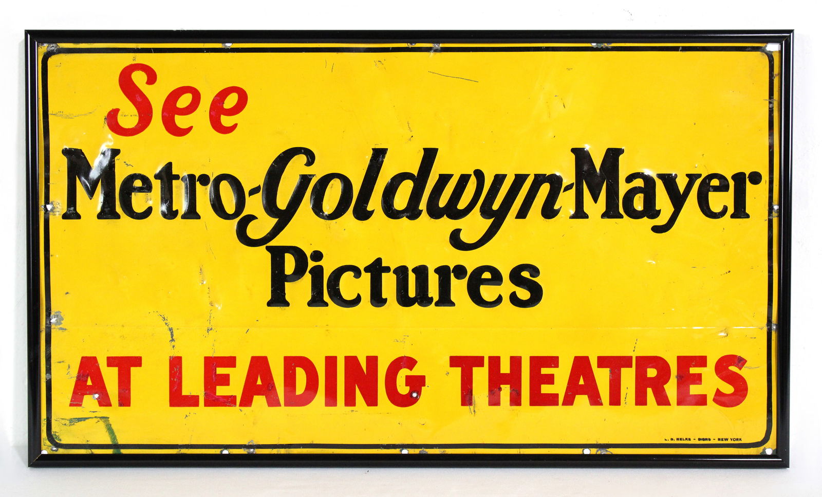 Metro-Goldwyn-Mayer Pictures Embossed Theatre Advertising Tin Sign: Framed. In-house shipping available. Dimensions: 12 x 21 x 1