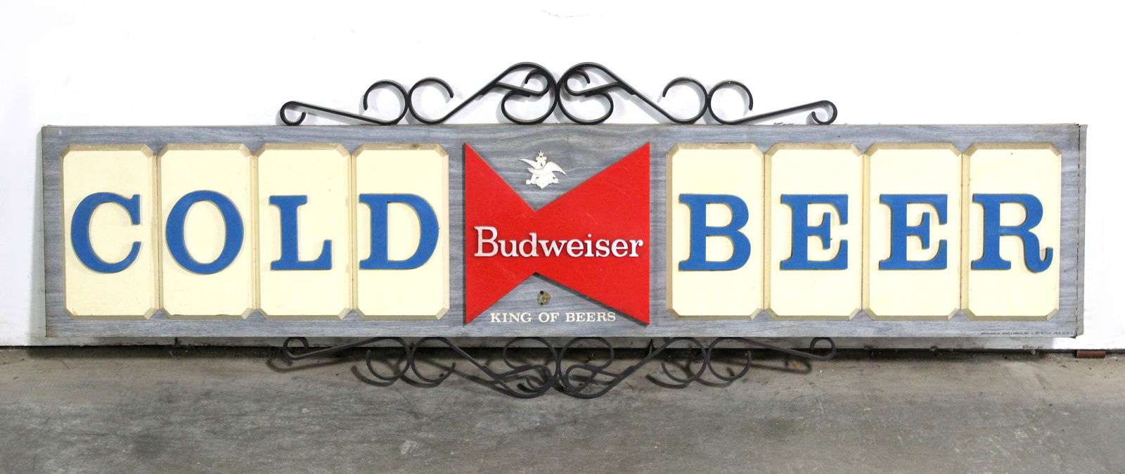 Budweiser Cold Beer Bowtie Masonite Sign: This item requires third-party shipping or pickup arrangements to be made. Dimensions: 16 x 47 x 2