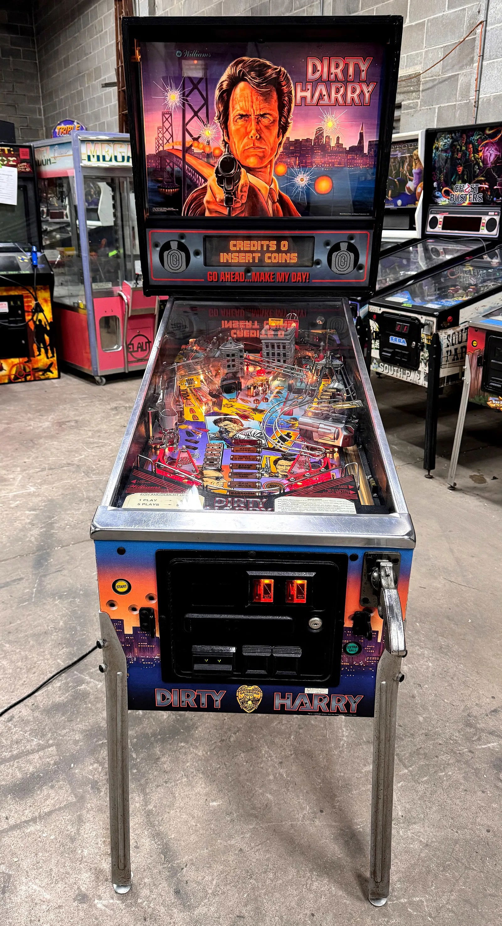 Williams Dirty Harry Pinball Machine: Working. Bill acceptor / door lock not included. Dimensions: 70 x 31 x 54