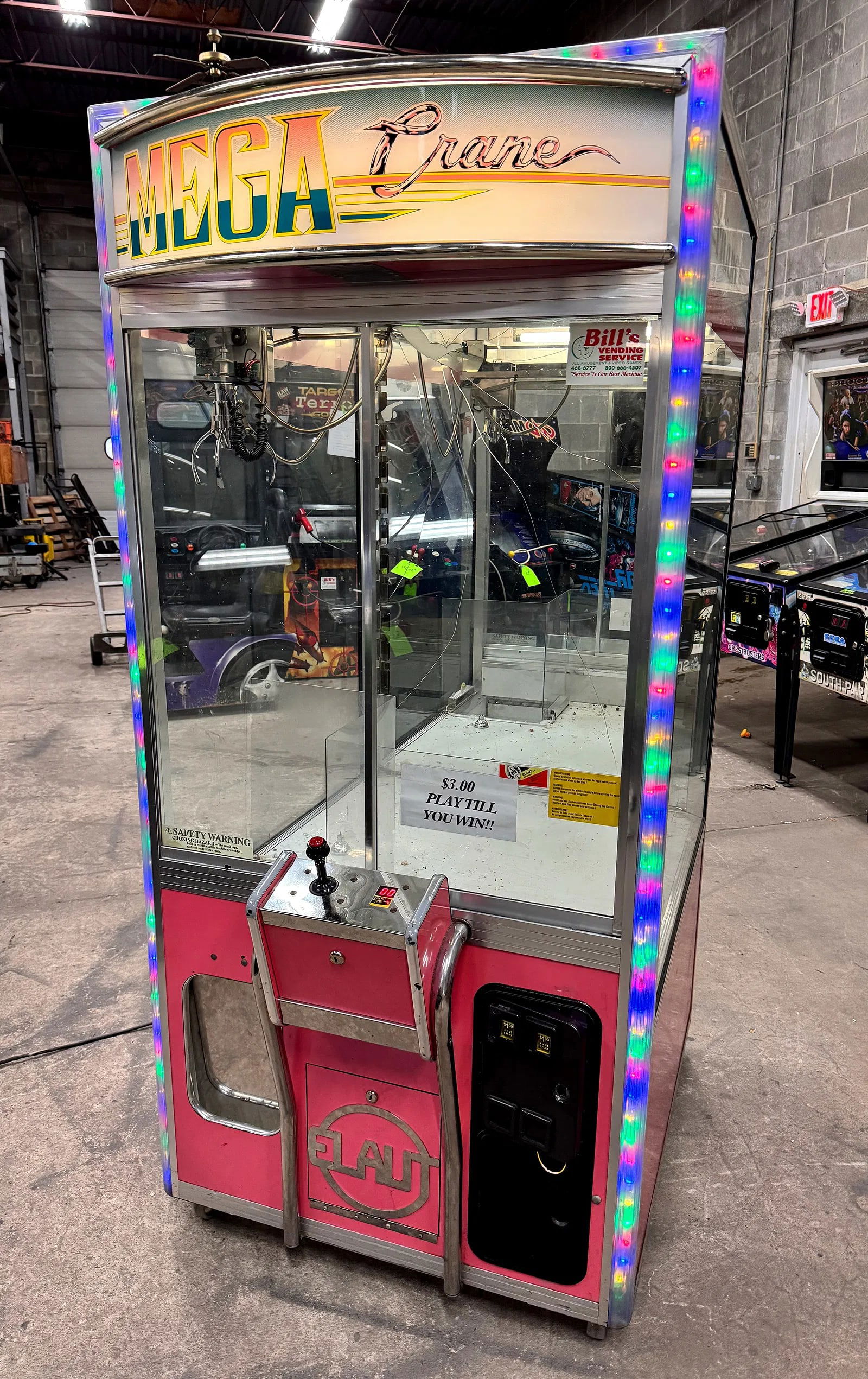 Elaut Mega Crane Arcade Game: Mirrored glass is broken. Dimensions: 78 x 36 x 46 ***This is a remote auction in Sewell, New Jersey. Pickup or third-party shipping is required on this item. A list of suggested shippers can be found