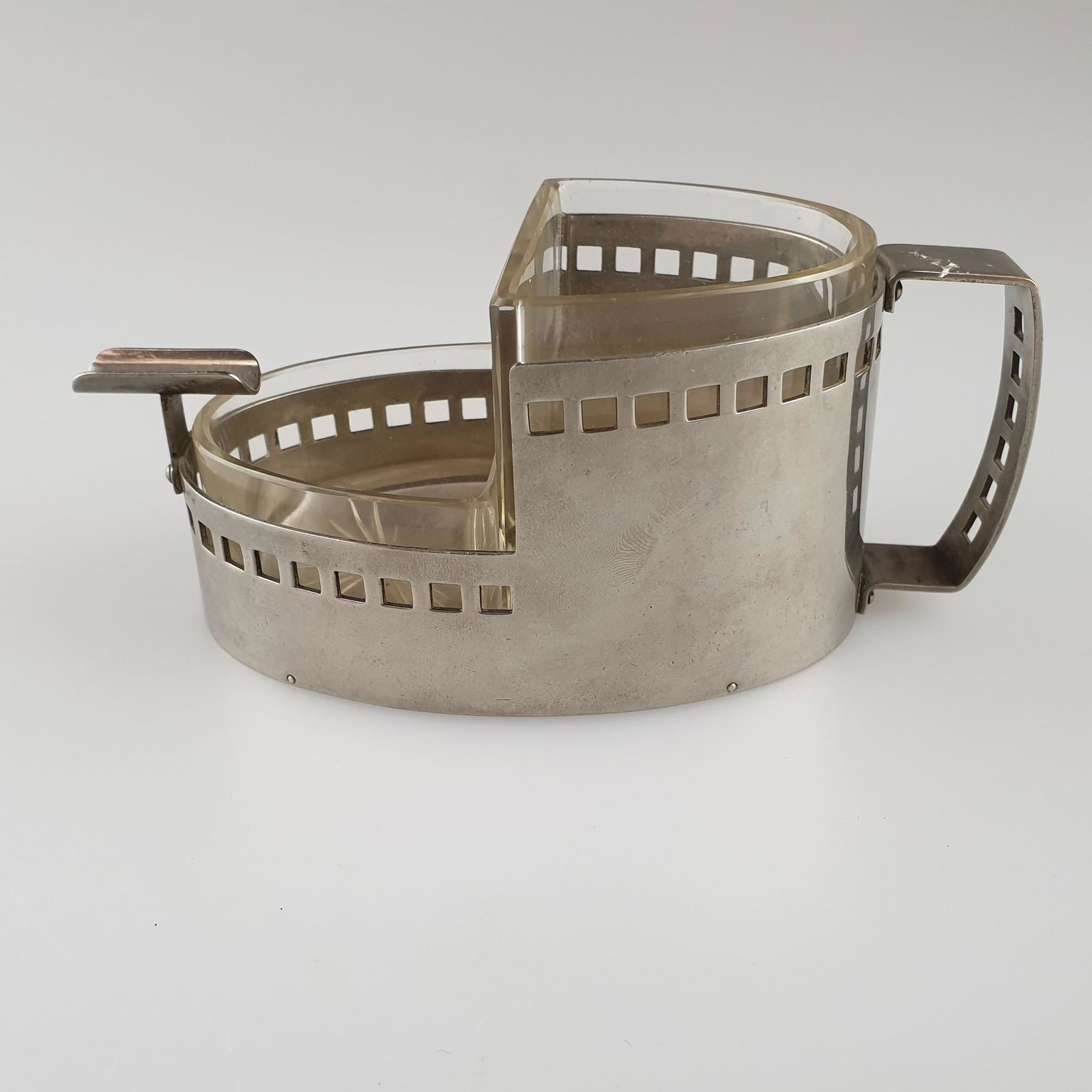 Raucherset - wohl Argentor-Werke Rust & Hetzel, Wien,: Raucherset - wohl Argentor-Werke Rust & Hetzel, Wien, Metall/Glas, mit durchbrochenem Quadratmuster im Stil von Josef Hoffmann, gestufter Metallkorpus mit zwei Glaseinsätzen und Zigarettenablage,