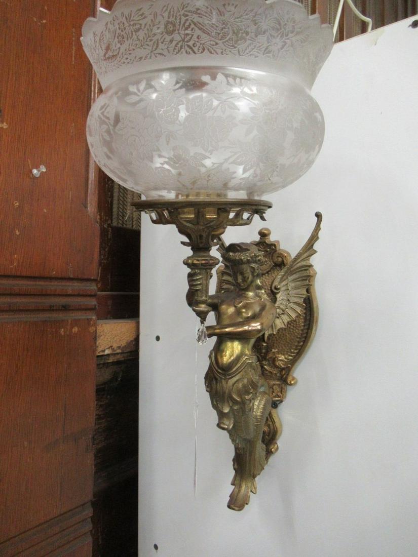 Brass Colored Wall Sconce w/ Winged Woman: Brass Colored Wall Sconce w/ Winged Woman and Glass Shade, Approx. 12" long - 15" w/ shade on, 7.75" deep, 5" wide - 7.5" shade width