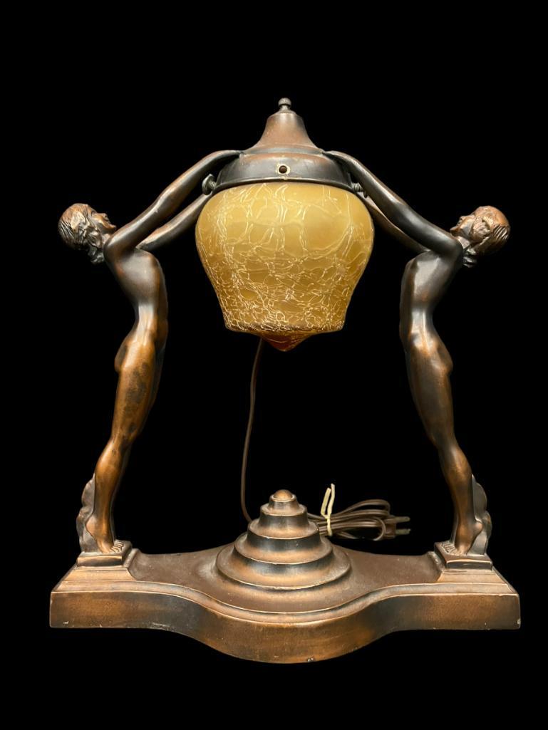 Nuart Art Deco Double Nude Figure Lamp: Nuart Standing Double Nudes arms raised together holding shade holder mount above w/under-mount Acorn Shaped amber crackle shade drops down between them. All original bronze wash finish and orig. shad