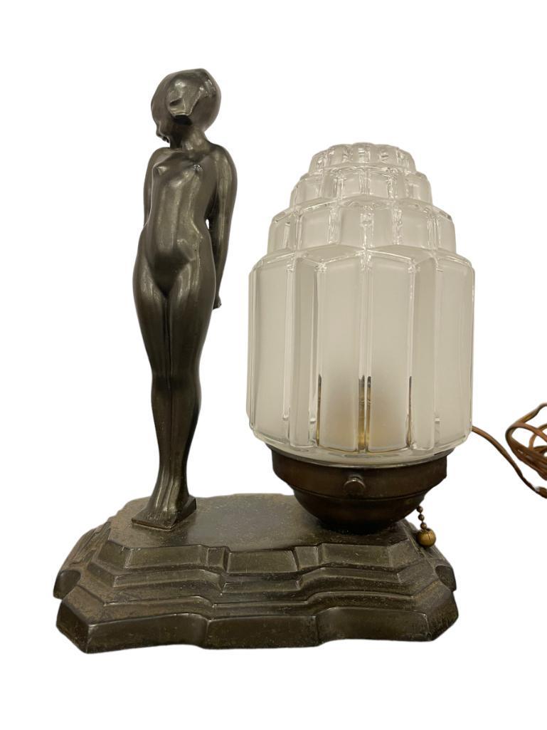 1920's Frankart Nymph Nude Figure Lamp: Frankart single Nymph nude looking Coy against a frosted/etched Skyscraper lamp shade and base. Lamp measures: 9 1/2" high x 8" wide x 4 3/4" deep.