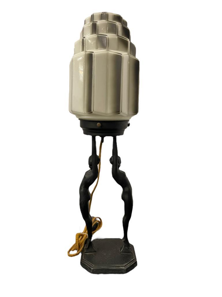 1920's Frankart Art Deco Lamp: Frankart L211 Art Deco Double Standing Nudes in black Jap finish, holding aloft w/Skyscraper ivory/white & black deco shaded original shade, 1927 and patent D77201, Measures approx. 6-1/2"dia x 20-1/2