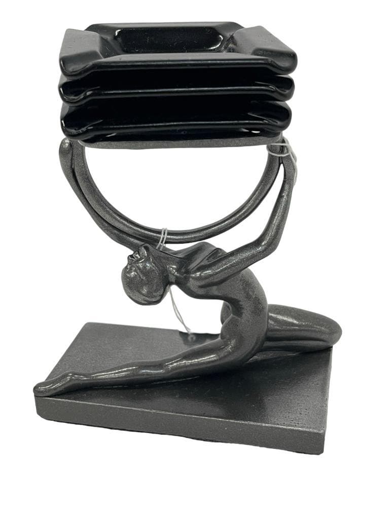 Female Nude Holding Ash Receiver: In the style of Frankart stretching nude figure T362 on rectangle base. Female holds aloft a convenient ash receiver for 3 black ceramic enamel coated black pin-dishes or ashtray inserts. Approx. 6 1/
