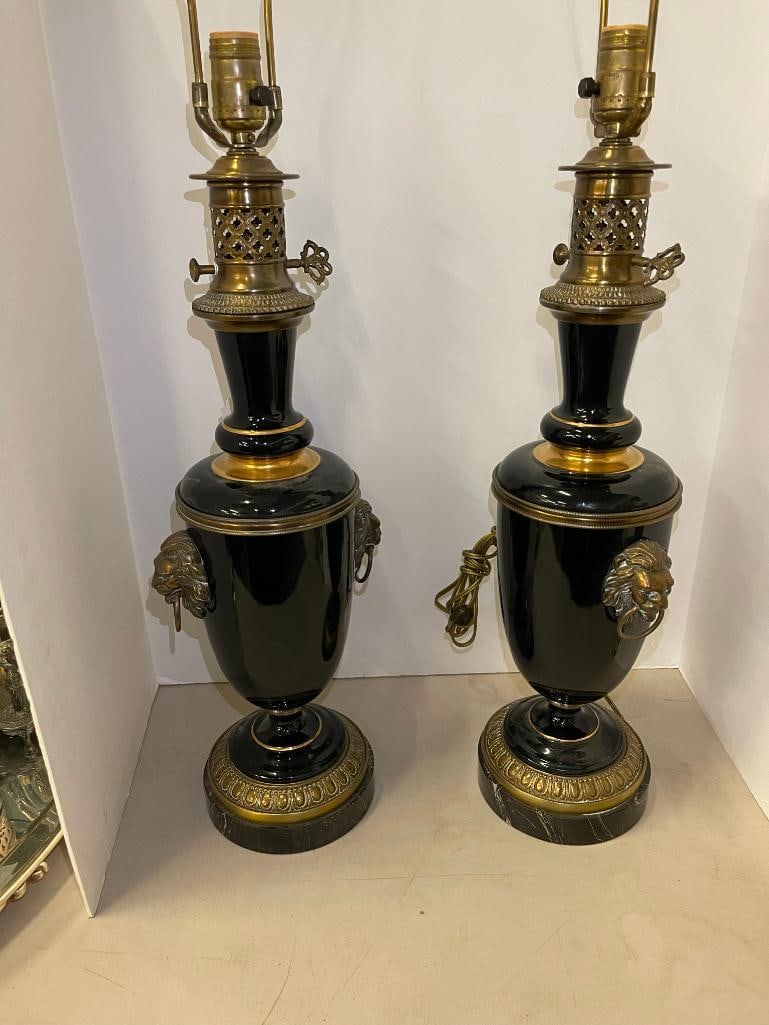 Black Porcelain Lamps w/ Lion Heads: Pair of black porcelain lamps w/ lion heads on marble bases. Approx. 6"diam x 39 tall.