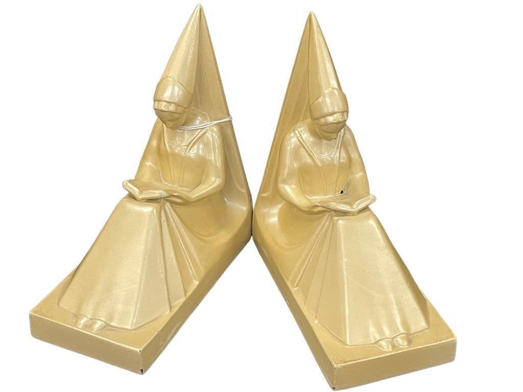 Pair of Bookends: Nuart Bookends w/ seated Princess Damsel Nun reading book with pointed deco hat and flowing robe. Both signed on low back Nuart & NYC. All with original finish, approx. 6 1/8" H. A few minor touch-ups